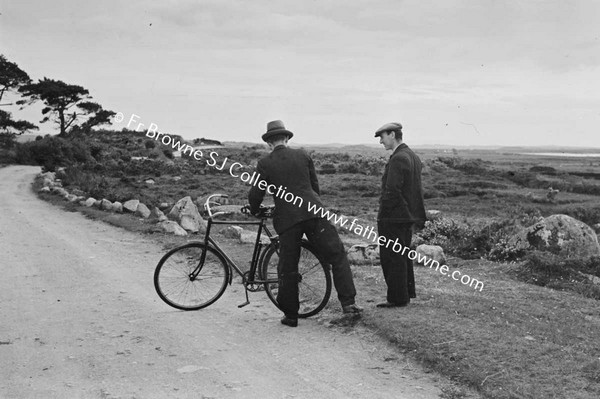 TWO MEN WITH BICYCLE